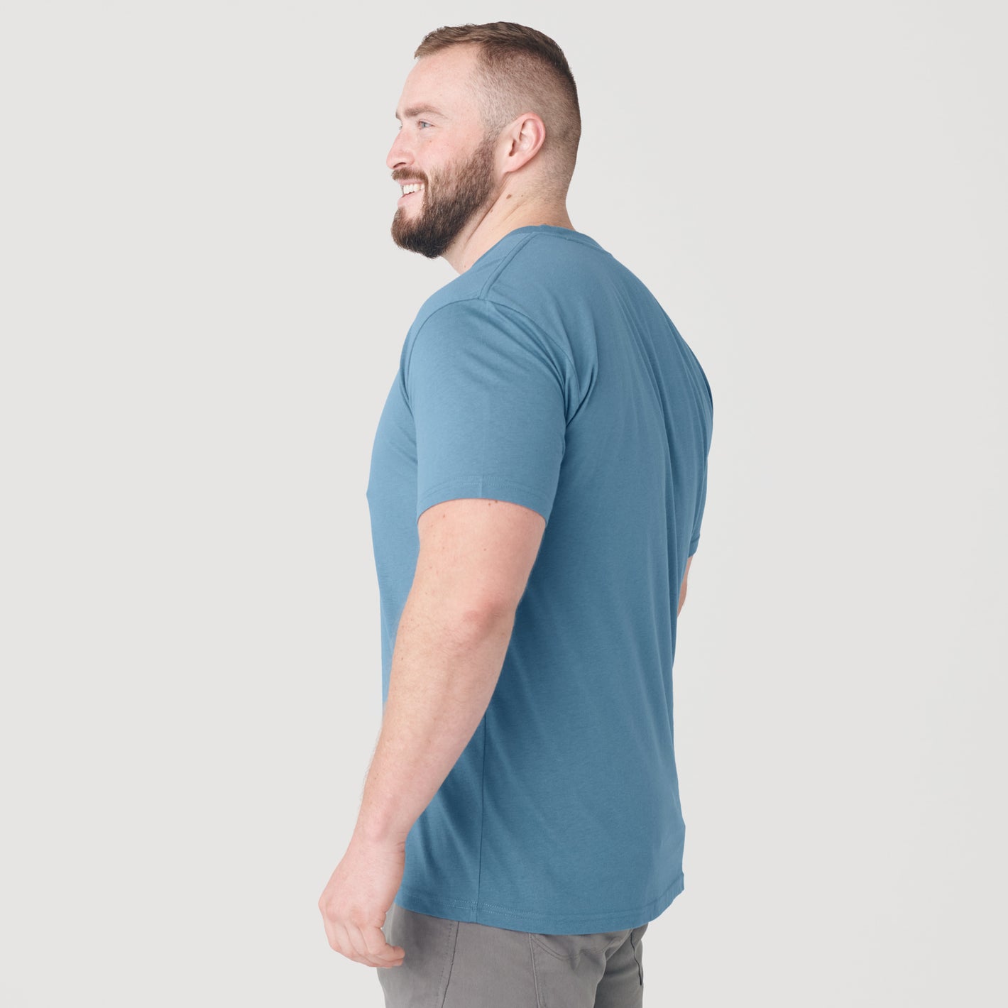 Man in Bluestone Short Sleeve Crew Neck Tee, shown from side and back.