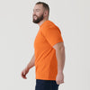 Man in Orange Short Sleeve Crew Neck Tee smiling in profile.