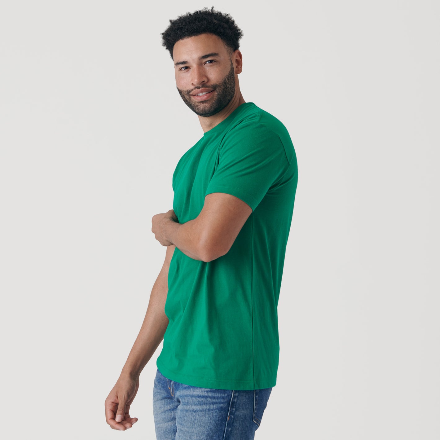 Man wearing Kelly Green Short Sleeve Crew Neck Tee.