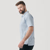 Man in Heather Pale Blue Short Sleeve Polo, side view.
