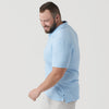 Man wearing Oxford Blue Short Sleeve Polo, smiling, looking down.