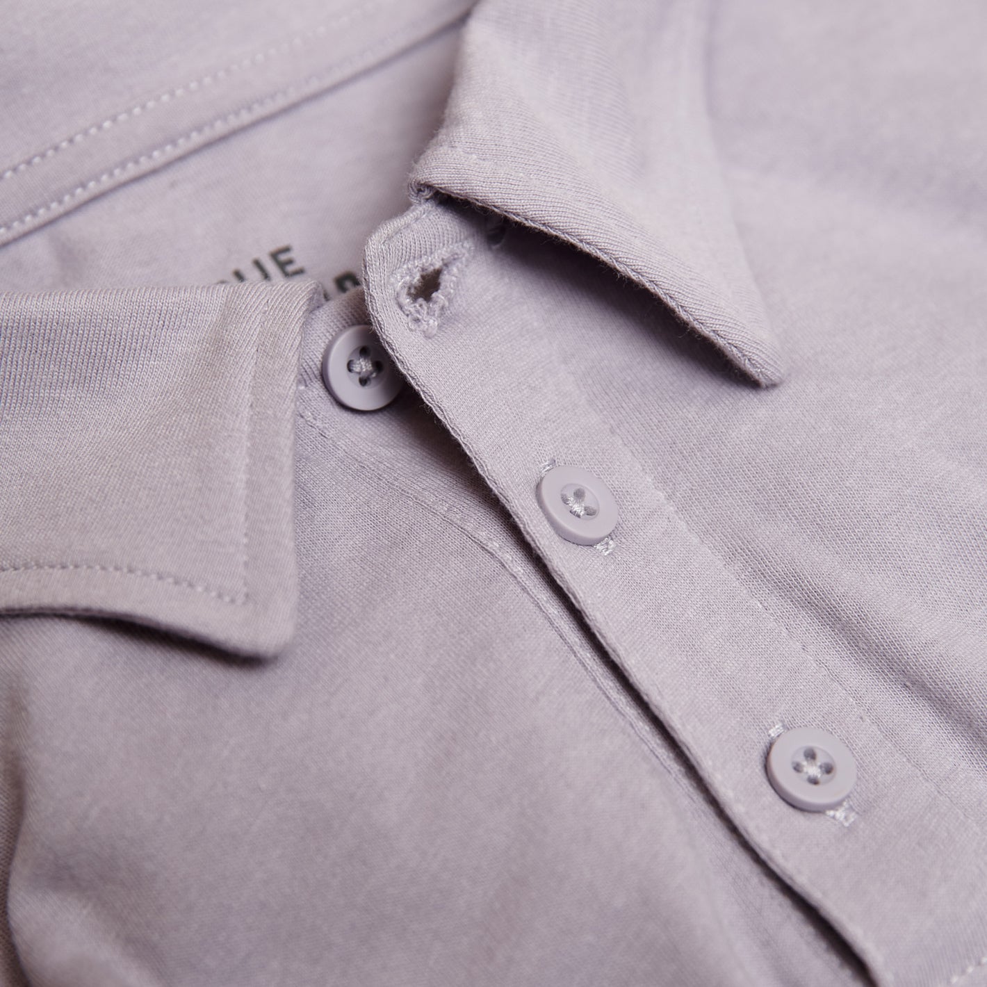 Lilac Gray Short Sleeve Polo with collar and two-button placket.