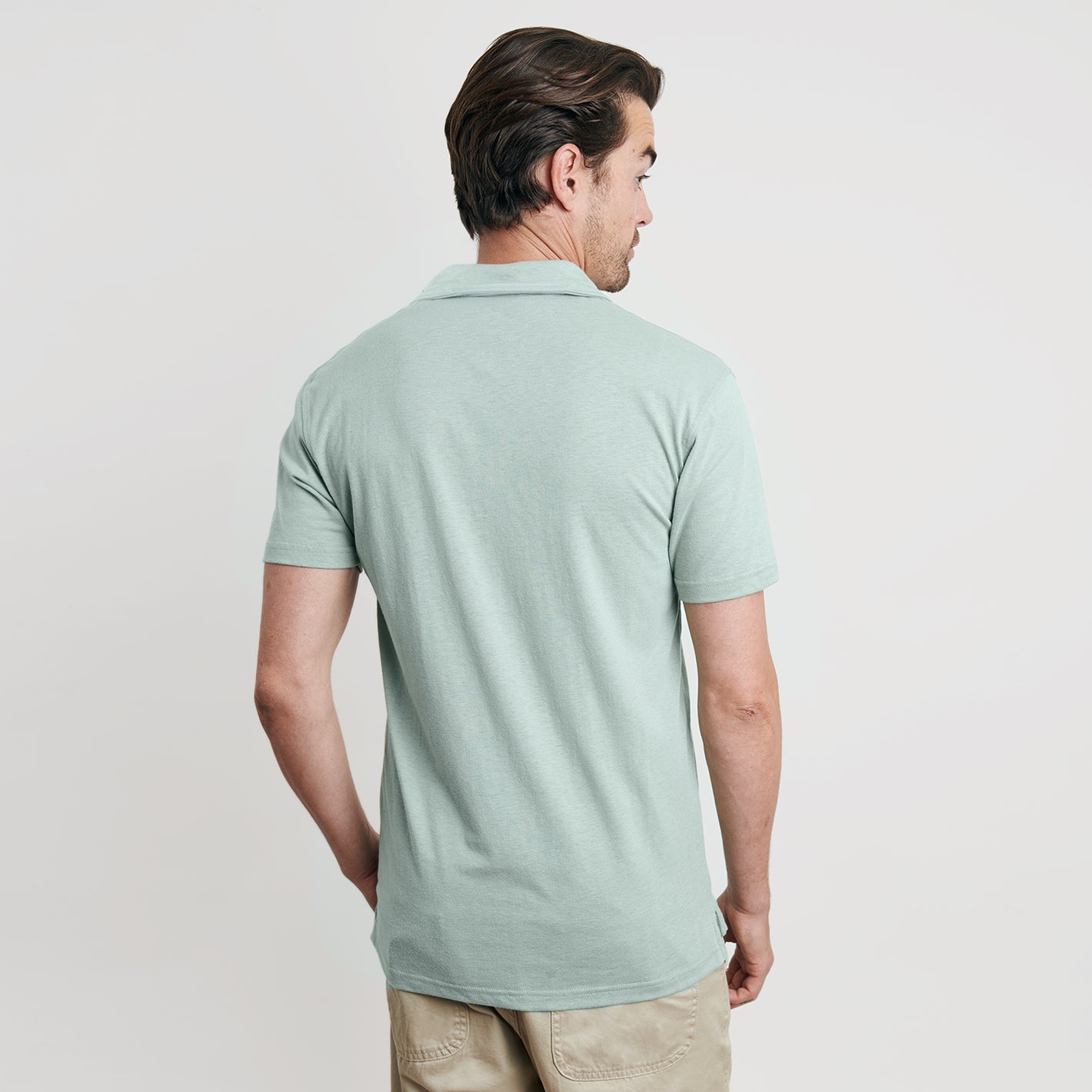 Man wearing Sage Short Sleeve Polo with light khaki pants.