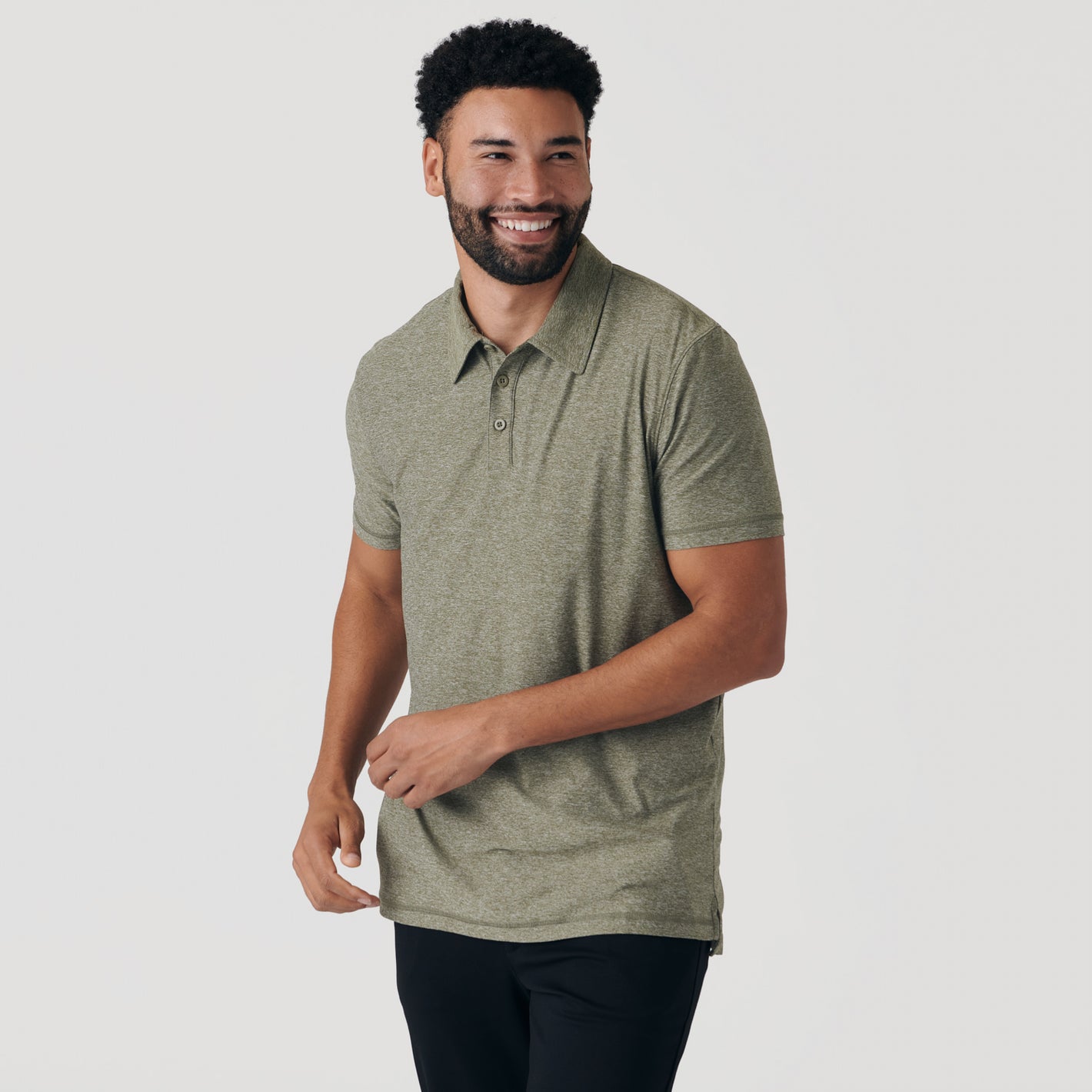 Man wearing Heather Military Green Active Short Sleeve Polo, smiling, gesturing.