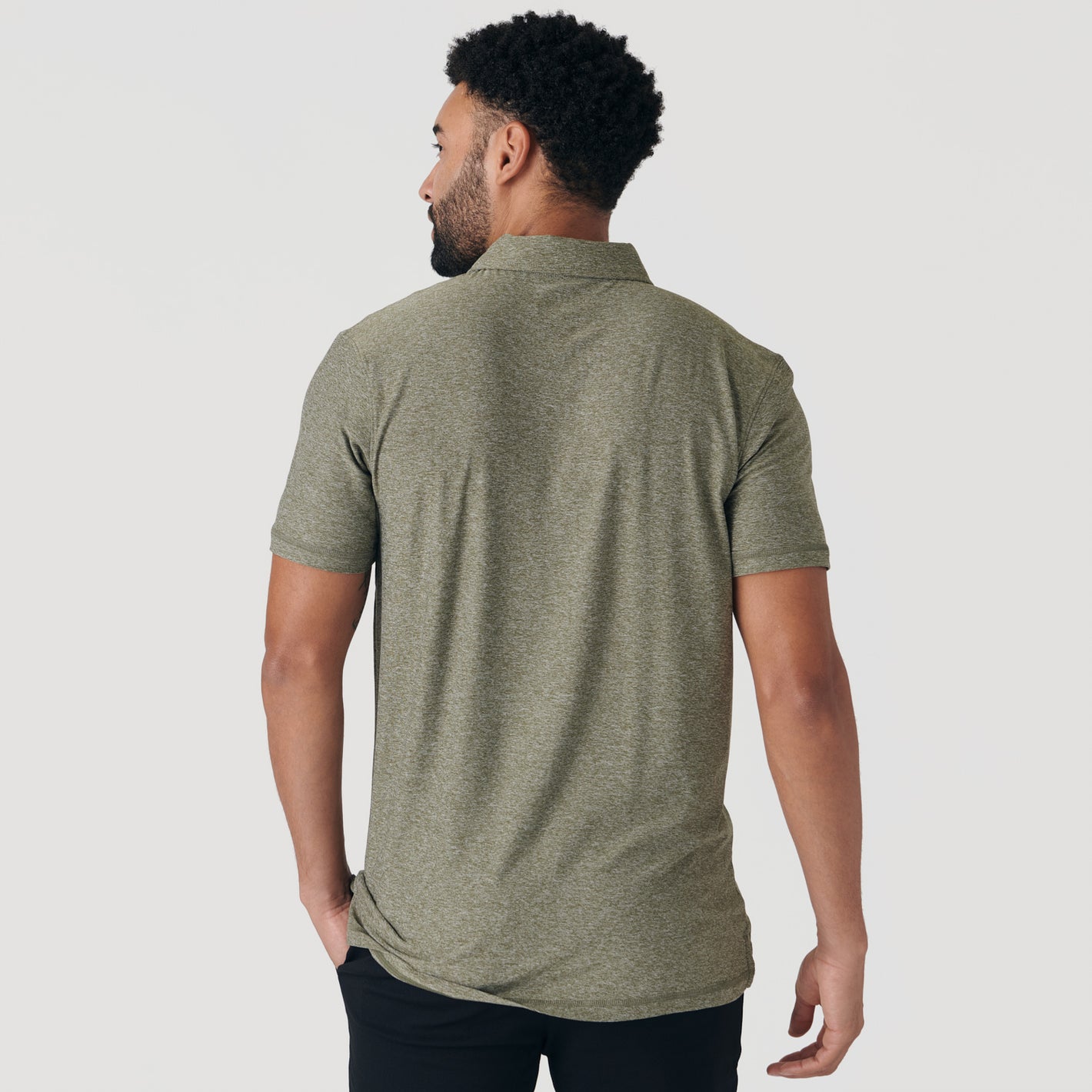 Man in Heather Military Green Active Short Sleeve Polo, back view.