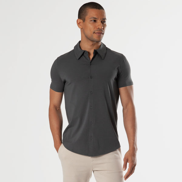 Male model wearing Carbon Short Sleeve Knit Shirt and light-beige trousers.