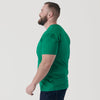 Man in Kelly Green V-Neck Tee, side view, casual pose.