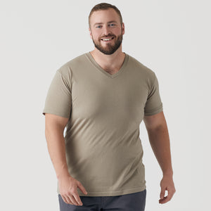 True ClassicMan wearing Military Beige Classic V-Neck T-shirt, smiling, light background.