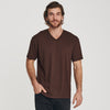 Man wearing Coffee V-Neck Tee with dark pants, hand in pocket.