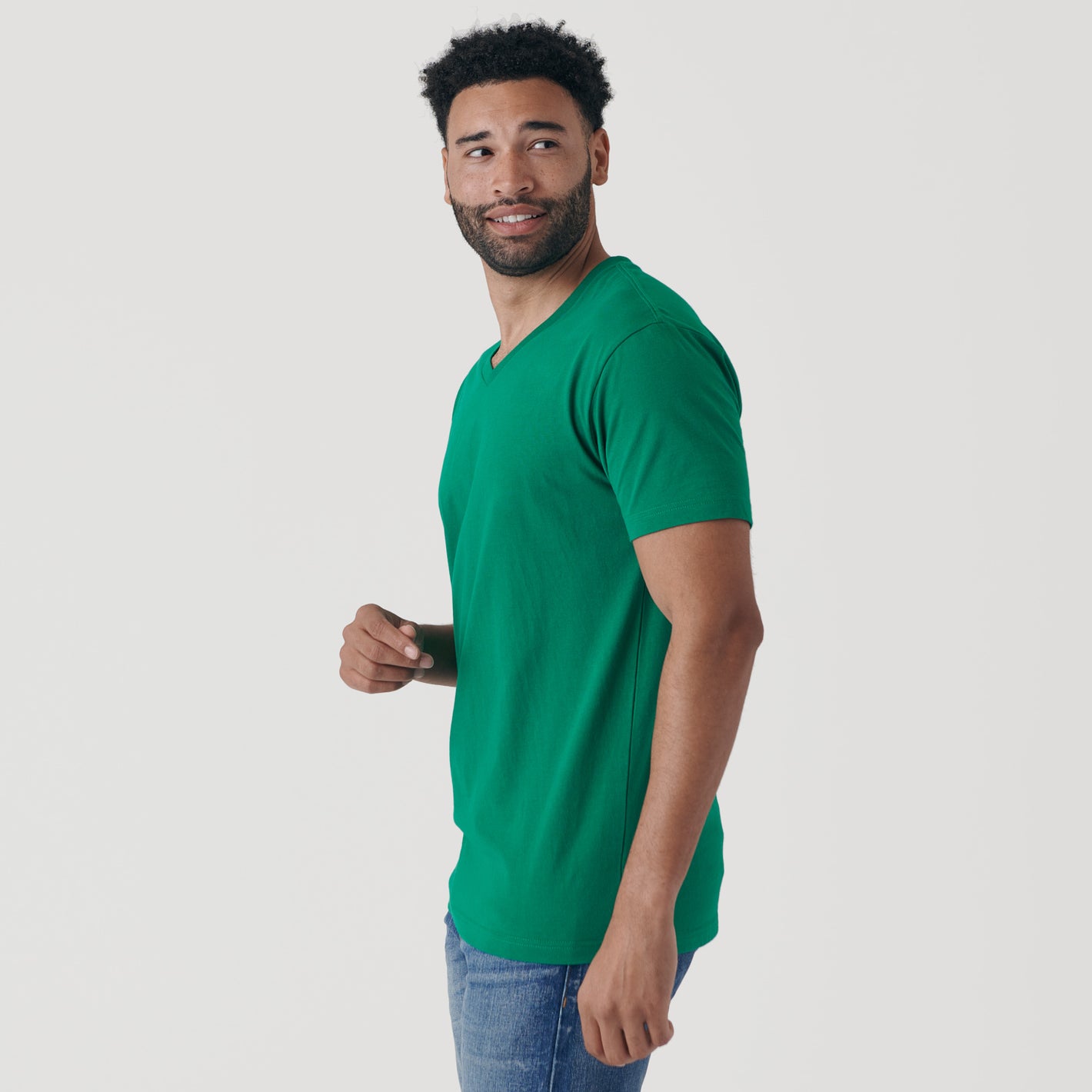 Man wearing Kelly Green V-Neck Tee in profile view.
