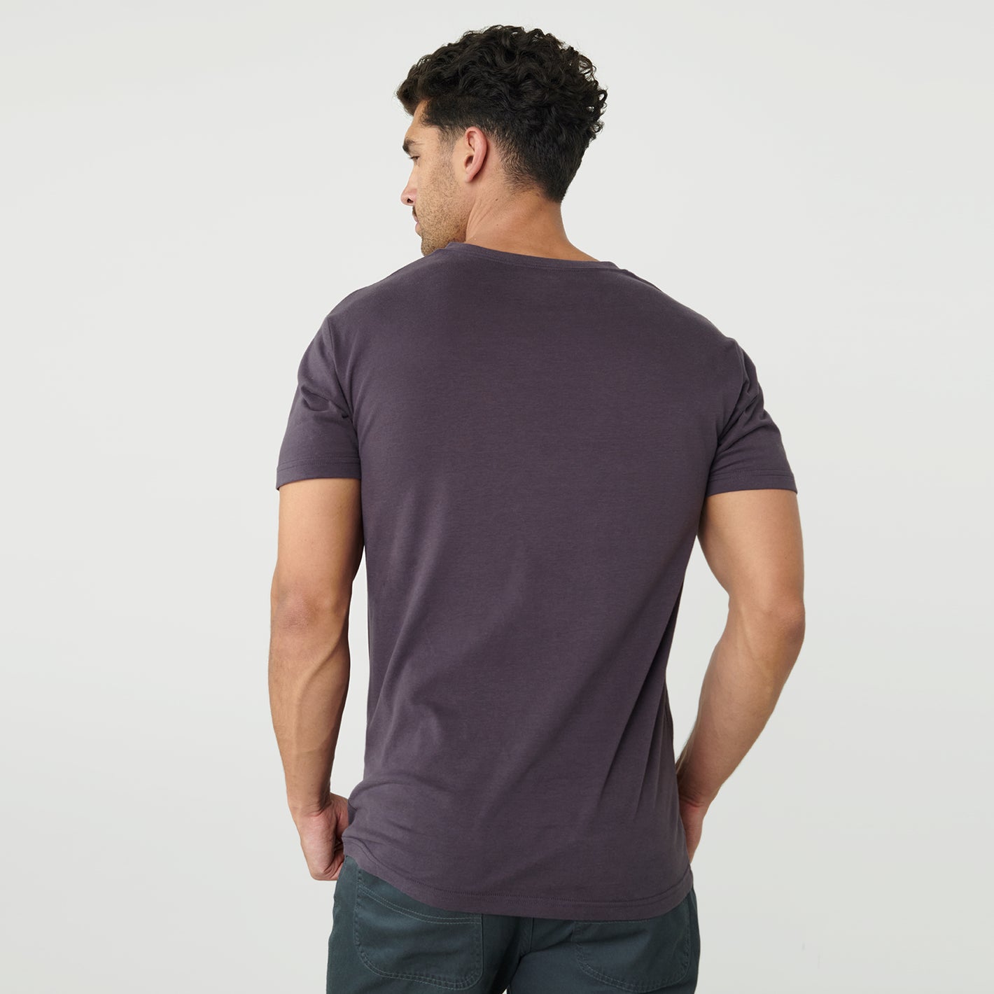 Man wearing Dark Purple V-Neck Tee from behind.