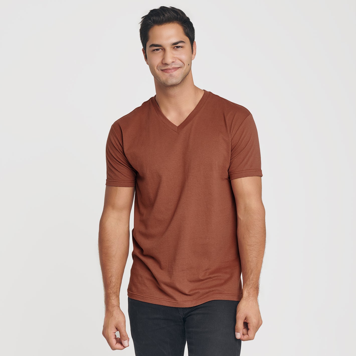 Young man in Red Rock V-Neck Tee, slim-fit trousers.