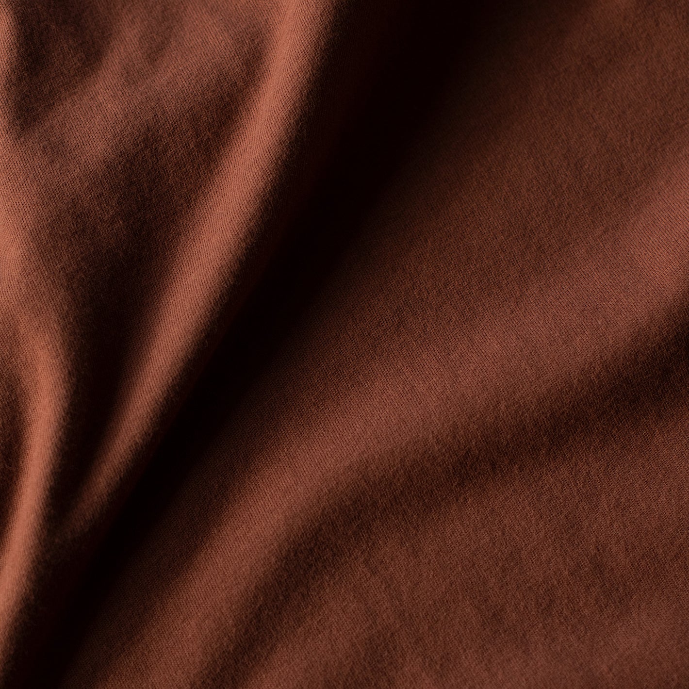 Close-up of Red Rock V-Neck Tee's brown fabric weave.