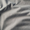 Close-up of Slate V-Neck Tee's soft, light-gray fabric folds.