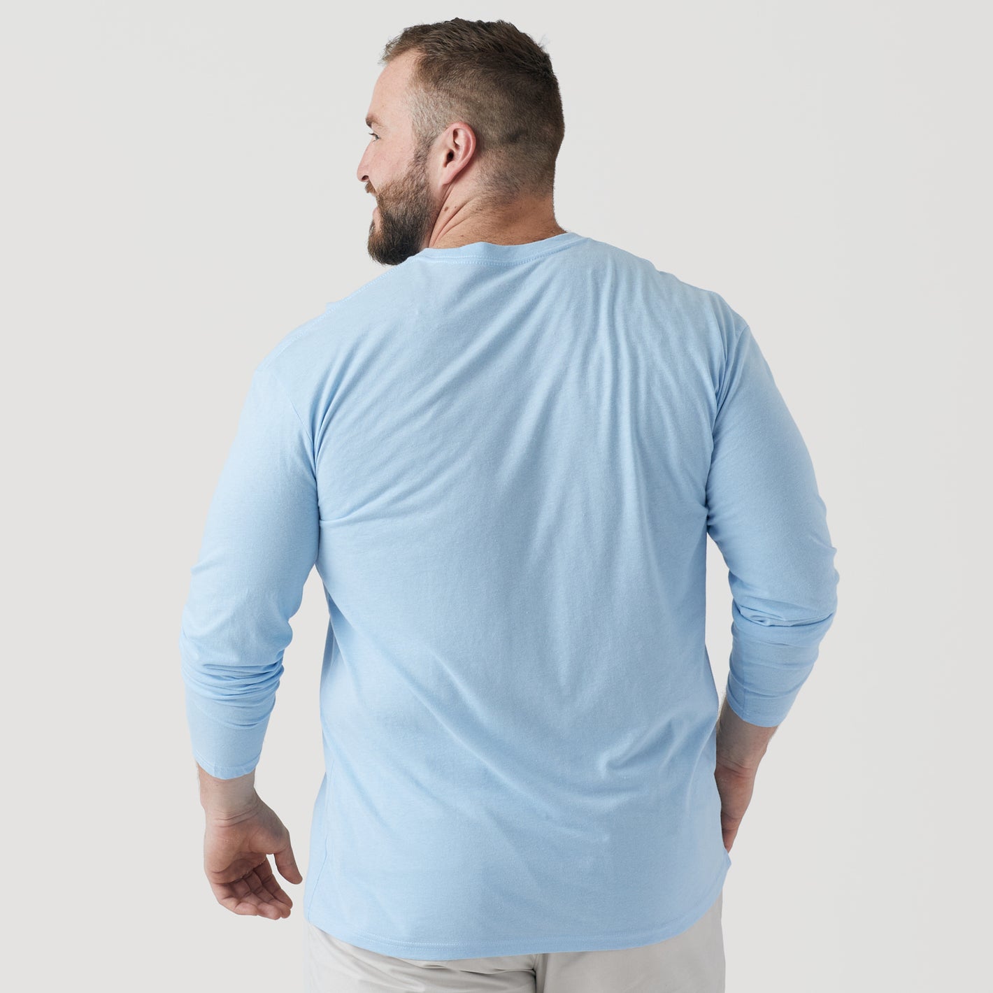 Man wearing Oxford Blue Long Sleeve Crew Neck Tee, seen from behind.