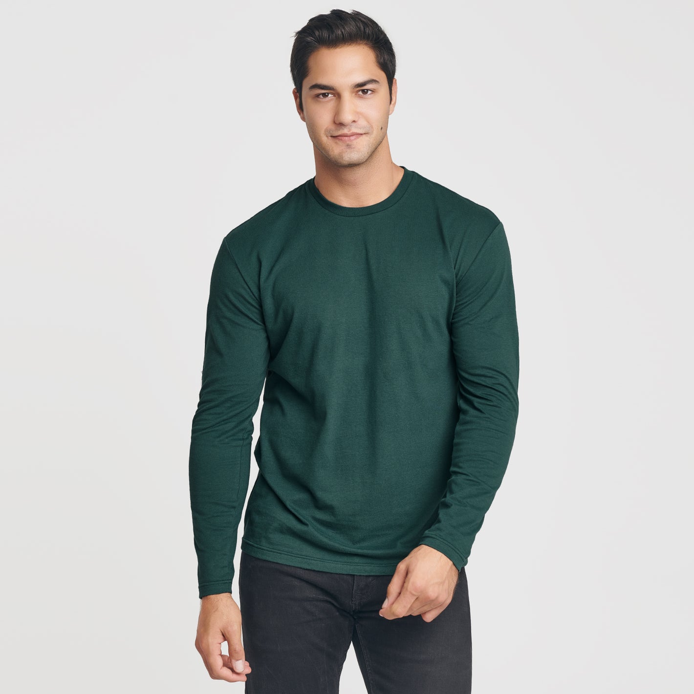 Man wearing Forest Green Long Sleeve Crew Neck Tee with dark pants.