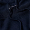 Navy Waffle Hoodie close-up, showing texture and drawcord details.