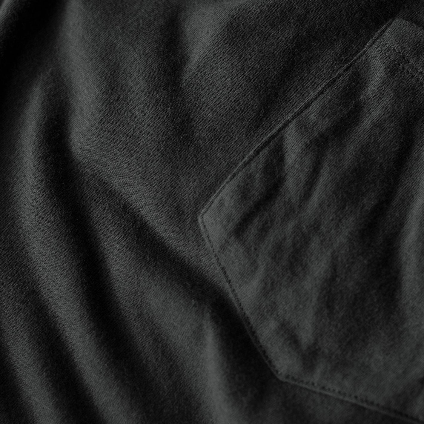 Carbon Pocket Crew Tee close-up, highlighting fabric texture and pocket stitching.